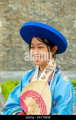 Vietnam, Hanoi, city center, Thang Long Citadel, young woman in traditional imperial outfit Stock Photo