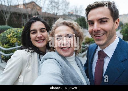 Happy business team taking a selfie outdoors in urban setting Stock Photo