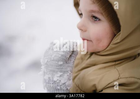 Close-up of a happy child enjoying a snow day in winter Stock Photo