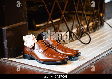Brown leather dress shoes with a floral pocket square. Stock Photo
