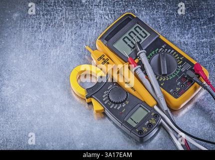 Digital clamp meter electric tester multimeter on metallic background Stock Photo