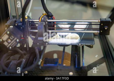 3D printer creating plastic objects with precision and speed. The concept represents modern manufacturing, rapid prototyping, and the future of custom Stock Photo