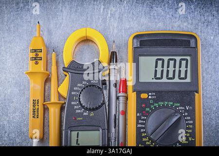 Digital clamp meter electrical tester multimeter on metallic background electricity concept Stock Photo