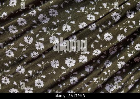 A mustard green canvas featuring a vibrant floral pattern, combining warm yellow tones with green, perfect for textile and design projects Stock Photo