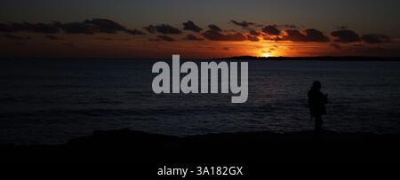 sunset at sea, waves and cliff, incredible sunset view bright colors of the sky spain balearic islands Stock Photo