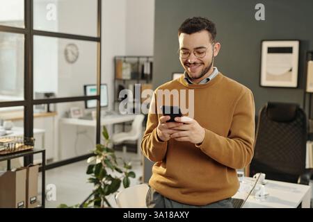 Man Using Phone in Office Stock Photo