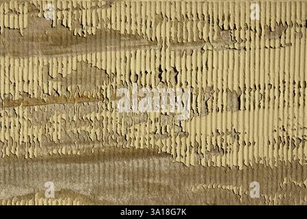 Cracked beige paint on sandstone wall Stock Photo