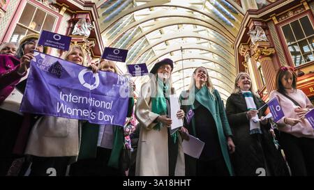 London, UK. 06th Mar, 2025. Celebrating International Women's Day with the motto 'Accelerate Action', the 'International Women's Day Choir' sing, here at the historic Leadenhall Market. The women and men, many of them in City of London roles, come together ahead of IWD. Organised by organised by Music in Offices (MIO), they sing at three iconic landmarks in the City of London, Leadenhall Market, Royal Exchange and Guildhall Yard, aiming to accelerate gender equality. Credit: Imageplotter/Ģ����ý Live News Stock Photo