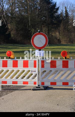 Road is blocked with warning barriers against passage Stock Photo