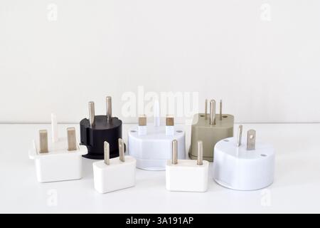A group of travel power adapters on white background Stock Photo