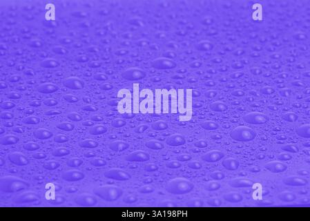 Texture of water drops on purple plastic as a background Stock Photo