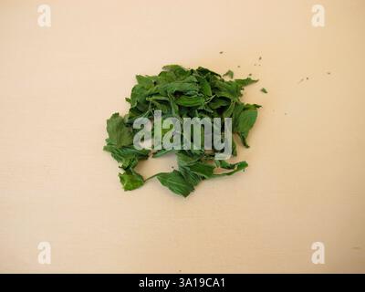 Alfalfa for herbal tea: dried alfalfa leaves on a wooden board Stock Photo