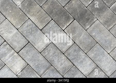 Gray concrete or stone pavers forming herringbone pattern Stock Photo