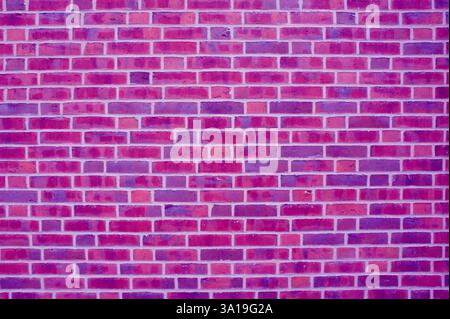 Cool background of a brick wall with stones in purple pink and violet Stock Photo
