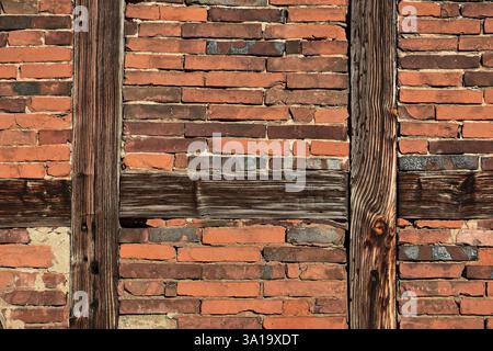 Half-timbered beams and brick wall of an old agricultural building Stock Photo