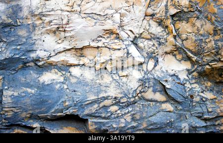 Texture of the mountain surface. Horizontal wallpaper of stone with texture in rust tones. Horizontal graphic resource for backgrounds with selective Stock Photo