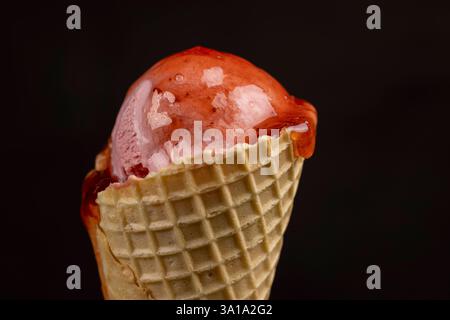 raspberry ice cream with red raspberry berries and fresh berry jam on a black background, close up of berry flavored ice cream with fresh raspberries Stock Photo