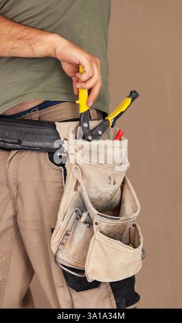 Worker uses tool belt, authentic and real moment. Slight blur of the hand and shears to tell the movement. Stock Photo
