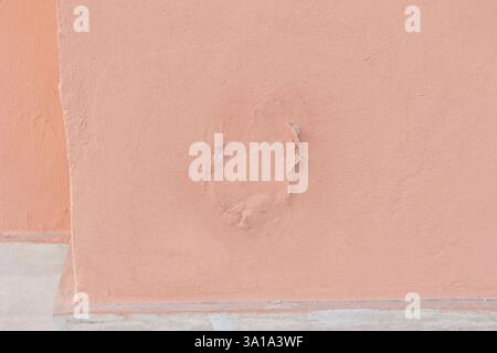 The house wall is being damaged by rising damp, leading to peeling paint Stock Photo