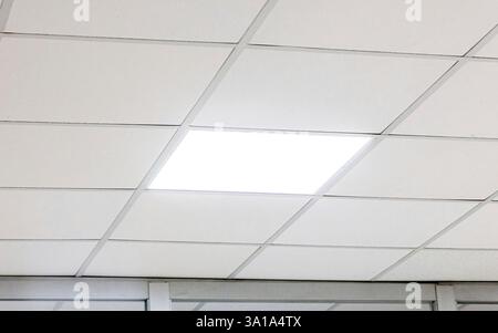 Modern design white office ceiling with led lighting. Stock Photo