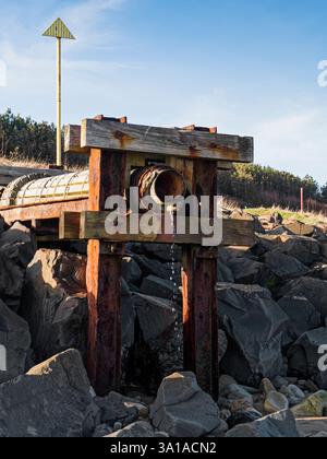 Broken and rusted pipeline leading into the North Sea at Cambois, Northumberland, UK, Stock Photo