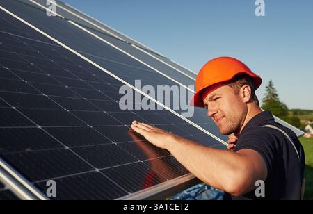 Man is doing operating and maintenance in solar power plant. Stock Photo