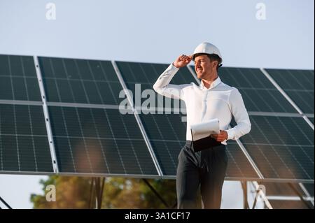 Man is doing operating and maintenance in solar power plant. Stock Photo