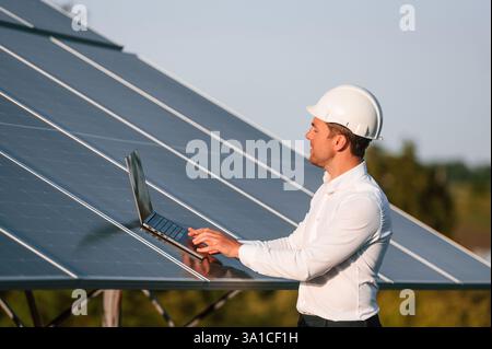 Man is doing operating and maintenance in solar power plant. Stock Photo