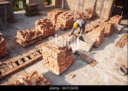 Top view. Handsome Indian man is on the construction site. Stock Photo