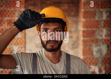 Portrait of handsome Indian man that is on the construction site. Stock Photo