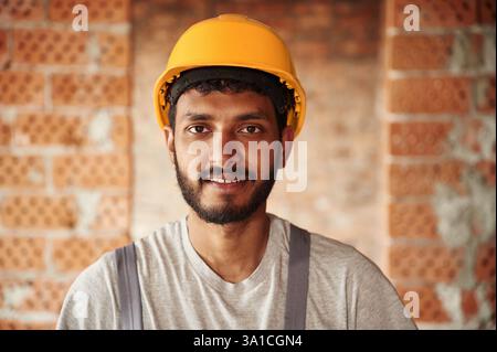 Portrait of handsome Indian man that is on the construction site. Stock Photo