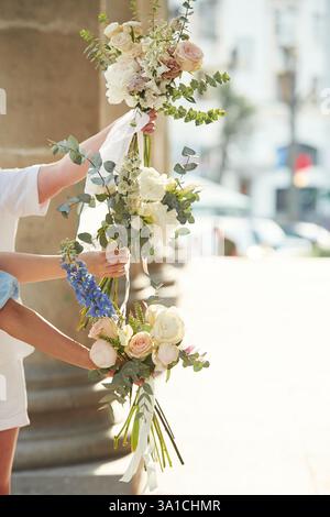 Close up view of women hands that are holding flowers. Stock Photo
