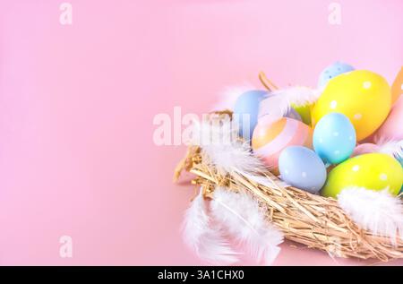 Nest with Easter eggs on a pink background with a copy space Stock Photo