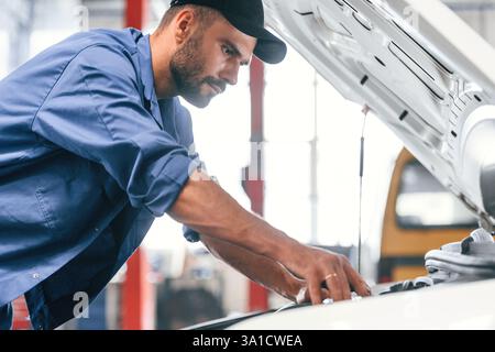 Auto mechanic working in garage. Repair service. Stock Photo