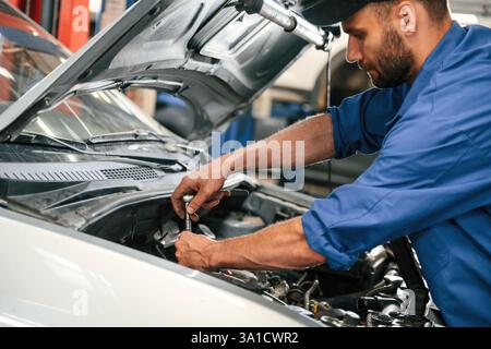 Repair service. Auto mechanic working in garage. Stock Photo