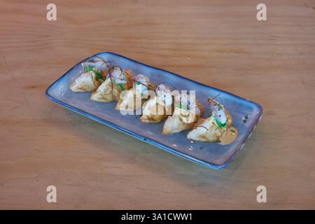 A plate of food with a blue plate and a white plate. The food is a type of food that is shaped like a ball Stock Photo