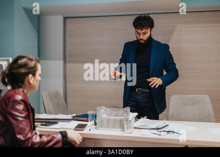 Professional discussion between colleagues in a modern office setting Stock Photo