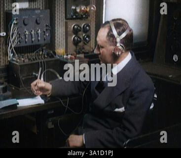 Edward, His Royal Highness the Duke of Windsor Watching an  Orchestra, 1937. From "Time To Remember -  The Powers That Were", 1930s (Reel 1); a documentary about various important figures of the 1930s.Italian Senator Guglielmo Marconi Using Radio Apparatus While Taking Notes, 1920. 'Signor Marconi, the radio expert. His work in the past had revolutionised wartime naval operations. Now, what new marvel was to come next? Messages to the Moon, some claimed'. From "Time To Remember - The Plunge Into Peace", 1920 (Reel 4); events of 1920 - weddings, women's rights, industrial un Stock Photo