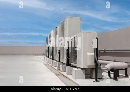 air conditioning and ventilation systems are installed on the roof of an industrial building. Stock Photo