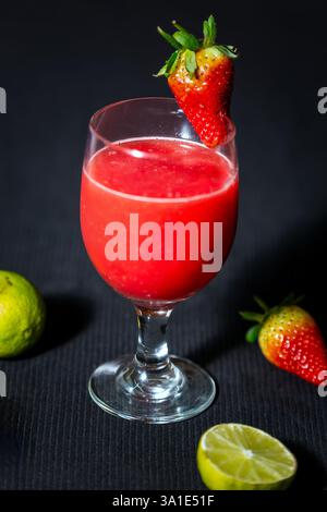 Glass of Watermelon Juice with lemon on dark background. Stock Photo