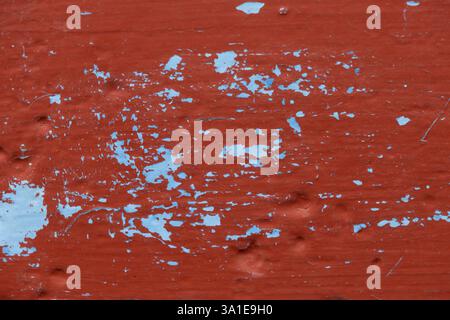 Close-up of blue paint under red paint brushed over steel Stock Photo