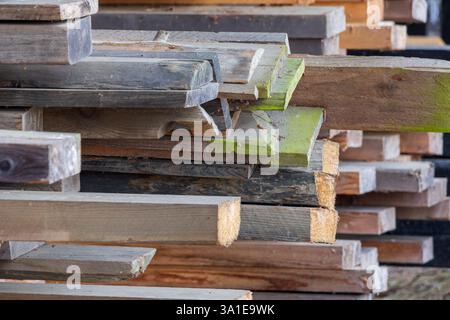 Weathered wood planks of varied shapes and colors, creating a rich texture for backgrounds Stock Photo