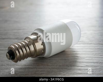 LED light bulb on wooden surface. Close up. Stock Photo