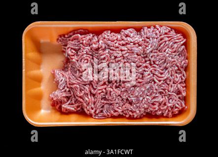 Raw ground meat minced in foam food container. Retail market sale Isolated black background Stock Photo