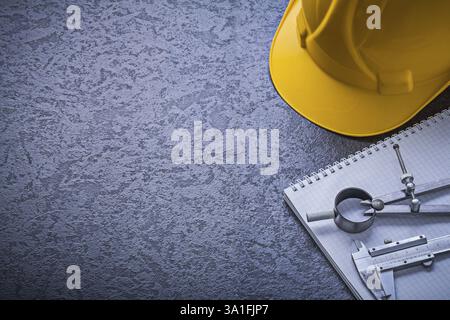 Notebook hard hat divider vernier scale copyspace construction concept Stock Photo