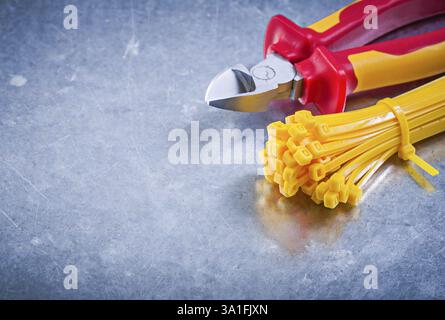 Nippers plastic zip cable ties on metallic background construction concept Stock Photo