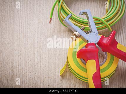 Insulating tape electric cable insulated wire strippers on wooden board electricity concept Stock Photo