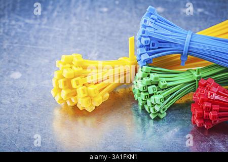 Multicolored plastic zip cable ties on metallic background construction concept Stock Photo