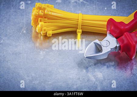 Nippers cable ties on metallic background construction concept Stock Photo