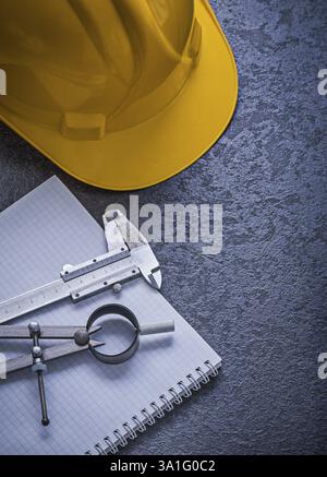 Notebook building helmet drawing compass vernier scale construction concept Stock Photo